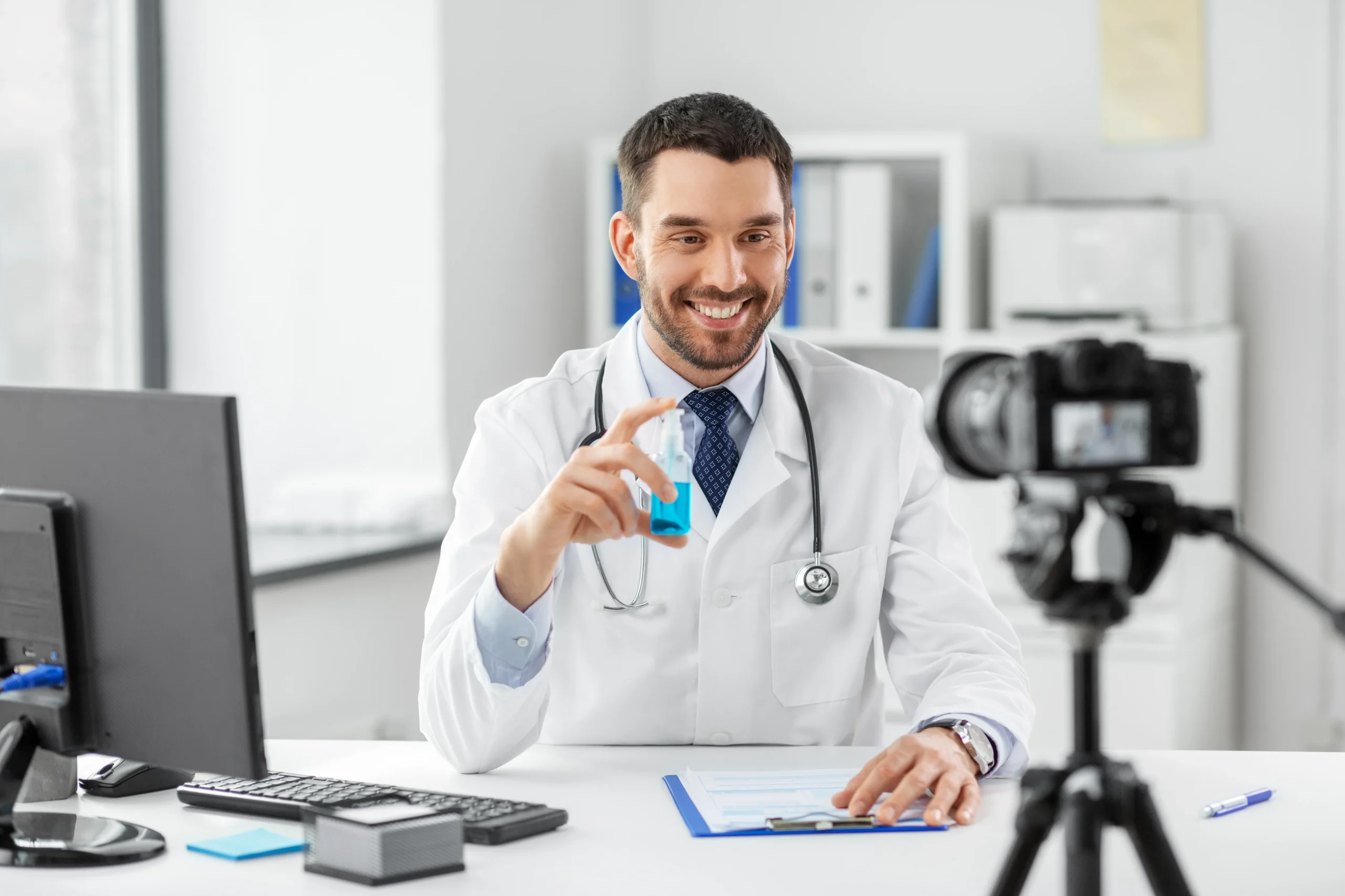 Doctor With Hand Sanitizer Recording Video Blog (1)